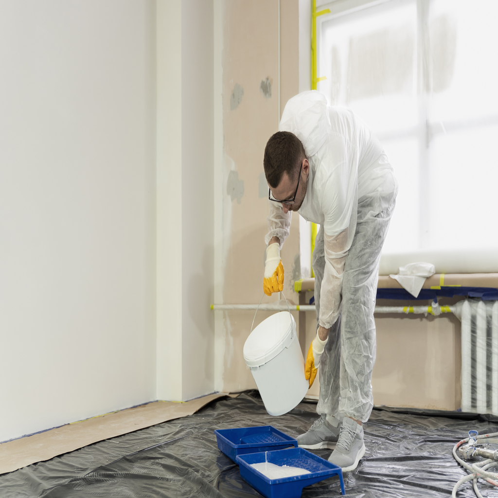 full shot man pouring paint