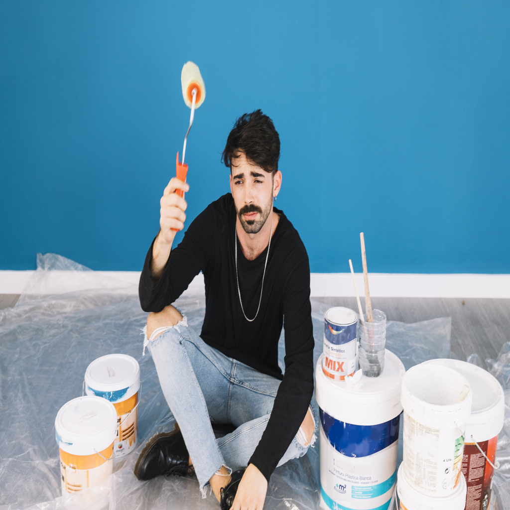 man with paint materials
